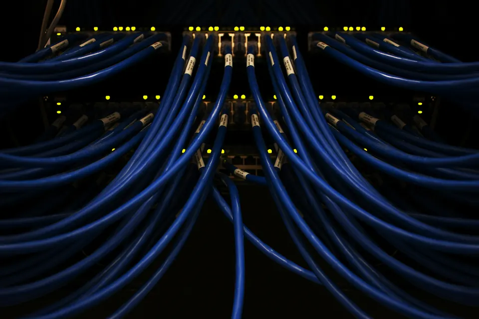 Patch cables running in rows between lit ports