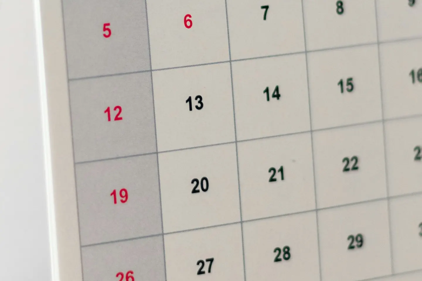 The dated grid of a desk calendar, where a repeating charge lands on the same day each month